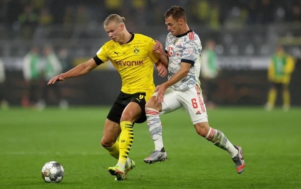 Erling Haaland of Dortmund is challenged by Joshua Kimmich of Muenchen during the Supercup 2021 match between FC Bayern München and Borussia Dortmund...