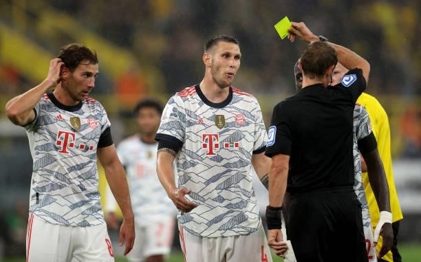 Niklas Suele of Muenchen reacts after receiving a yellow card during the Supercup 2021 match between FC Bayern München and Borussia Dortmund at...