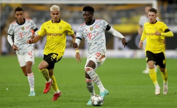Reinier of Dortmund challenges Alphonso Davies of Muenchen during the Supercup 2021 match between FC Bayern München and Borussia Dortmund at Signal...
