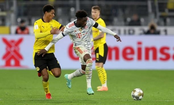 Jude Bellingham of Dortmund challenges Alphonso Davies of Muenchen during the Supercup 2021 match between FC Bayern München and Borussia Dortmund at...