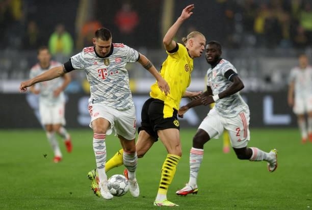 Niklas Suele of Muenchen challenges Erling Haaland of Dortmund during the Supercup 2021 match between FC Bayern München and Borussia Dortmund at...
