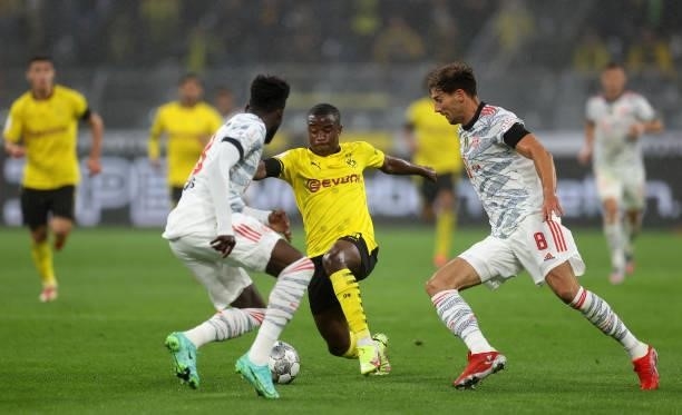 Youssoufa Moukoko of Dortmund is challenged by Leon Goretzka of Muenchen during the Supercup 2021 match between FC Bayern München and Borussia...