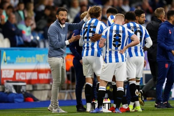 Carlos Coberán the Head Coach of Huddersfield Town talks to his players during a break in play during the Sky Bet Championship match between...