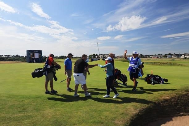 Pro-AM guest interacts with Nasa Hataoka of Japan after holing a bunker shot during the Pro-Am prior to the AIG Women's Open at Carnoustie Golf Links...