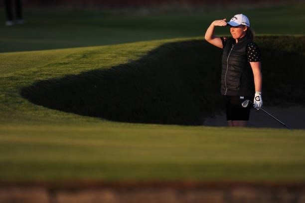 Gemma Dryburgh of Scotland looks on from a bunker on the eighteenth green during practice round prior to the AIG Women's Open at Carnoustie Golf...