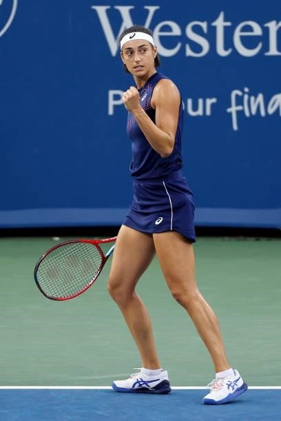 Caroline Garcia of France reacts after winning a point during her match against Garbine Muguruza of Spain during Western & Southern Open - Day 4 at...
