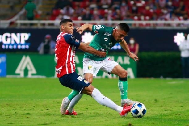 Gilberto Sepulveda of Chivas fights for the ball with Angel Mena of Leon during the 5th round match between Chivas and Leon as part of the Torneo...