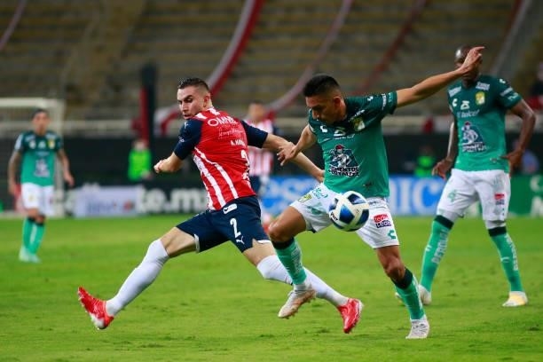 Manuel Mayorga of Chivas fights for the ball with Angel Mena of Leon during the 5th round match between Chivas and Leon as part of the Torneo Grita...