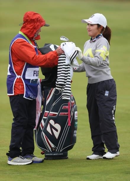 Ayaka Furue of Japan gives her club to her caddie on the second hole during Day One of the AIG Women's Open at Carnoustie Golf Links on August 19,...