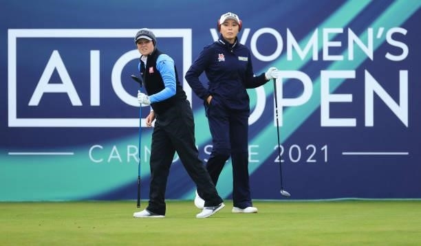 Ally Ewing of The United States and Mi Jung Hur of South Korea look on from the first tee during Day One of the AIG Women's Open at Carnoustie Golf...