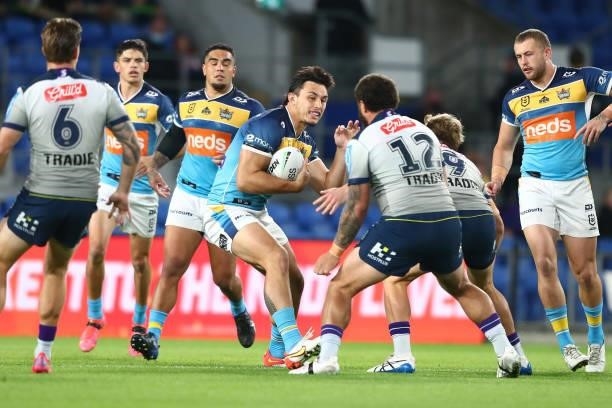 Tino Fa'asuamaleaui of the Titans is tackled during the round 23 NRL match between the Gold Coast Titans and the Melbourne Storm at Cbus Super...