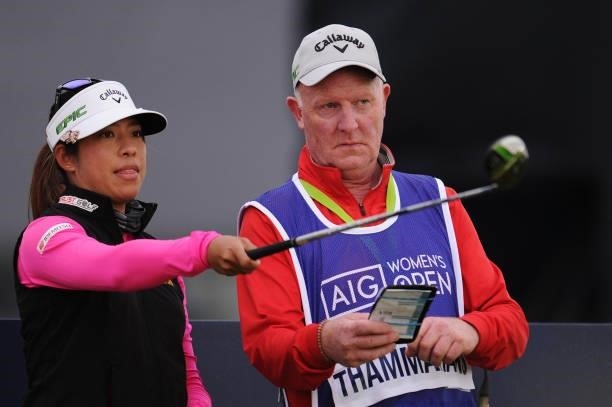 Prima Thammaraks of Thailand and her caddie prepare to tee off on the seventeenth hole during a practice round prior to the AIG Women's Open at...