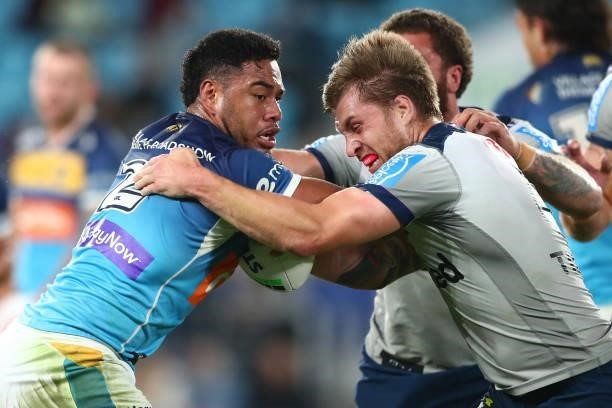 Greg Marzhew of the Titans is tackled during the round 23 NRL match between the Gold Coast Titans and the Melbourne Storm at Cbus Super Stadium, on...