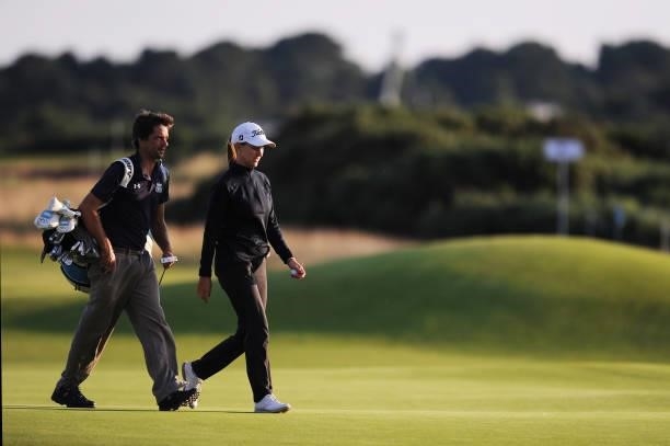 Magdalena Simmermacher of Argentina and her caddie walk off the sixteenth green during a practice round prior to the AIG Women's Open at Carnoustie...