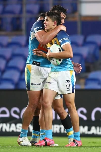 Jayden Campbell of the Titans celebrates scoring a try with team mates during the round 23 NRL match between the Gold Coast Titans and the Melbourne...