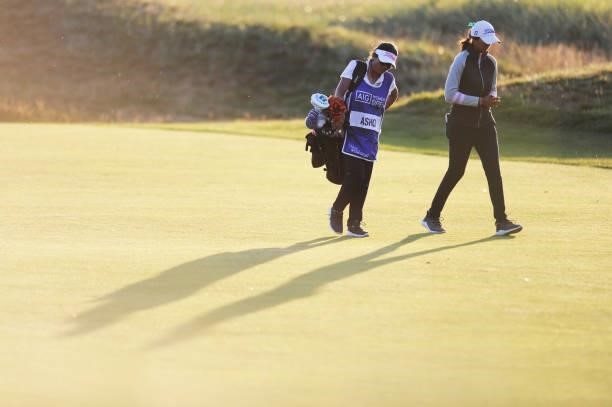 Aditi Ashok of India and her caddie walk along the eighteenth fairway during a practice round prior to the AIG Women's Open at Carnoustie Golf Links...