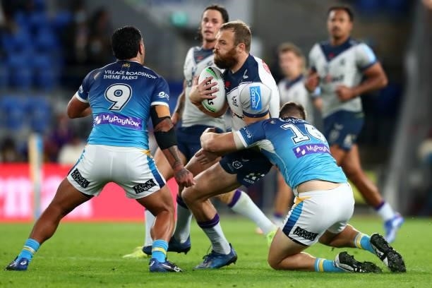 Tom Eisenhuth of the Storm is tackled during the round 23 NRL match between the Gold Coast Titans and the Melbourne Storm at Cbus Super Stadium, on...