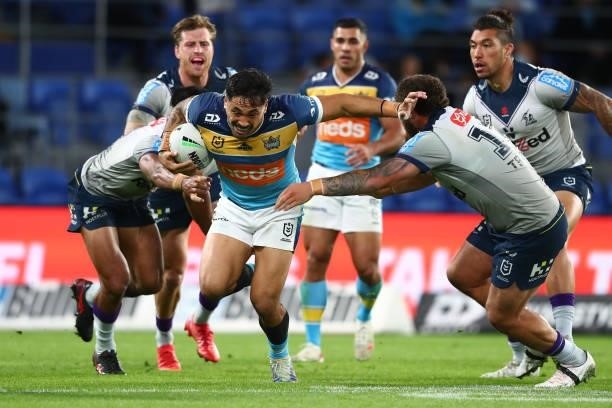 Patrick Herbert of the Titans takes on the defence during the round 23 NRL match between the Gold Coast Titans and the Melbourne Storm at Cbus Super...