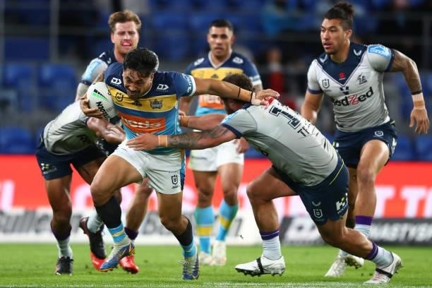 Patrick Herbert of the Titans takes on the defence during the round 23 NRL match between the Gold Coast Titans and the Melbourne Storm at Cbus Super...