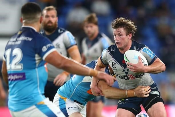Harry Grant of the Storm is tackled during the round 23 NRL match between the Gold Coast Titans and the Melbourne Storm at Cbus Super Stadium, on...