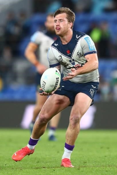 Cameron Munster of the Storm passes the ball during the round 23 NRL match between the Gold Coast Titans and the Melbourne Storm at Cbus Super...