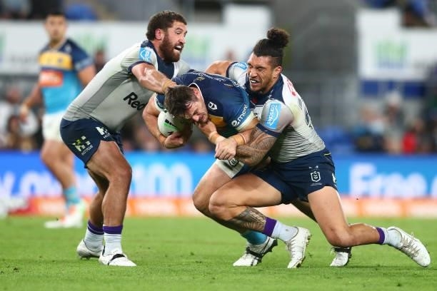 Jaimin Jolliffe of the Titans is tackled during the round 23 NRL match between the Gold Coast Titans and the Melbourne Storm at Cbus Super Stadium,...
