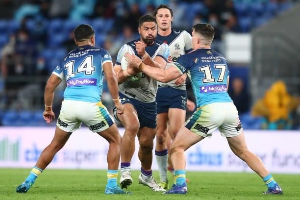 Kenneath Bromwich of the Storm is tackled during the round 23 NRL match between the Gold Coast Titans and the Melbourne Storm at Cbus Super Stadium,...