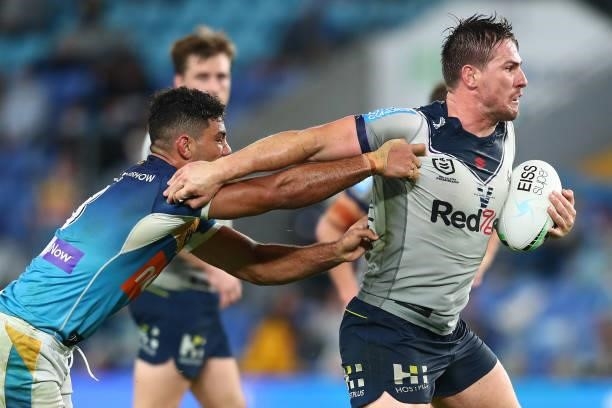 Chris Lewis of the Storm is tackled during the round 23 NRL match between the Gold Coast Titans and the Melbourne Storm at Cbus Super Stadium, on...