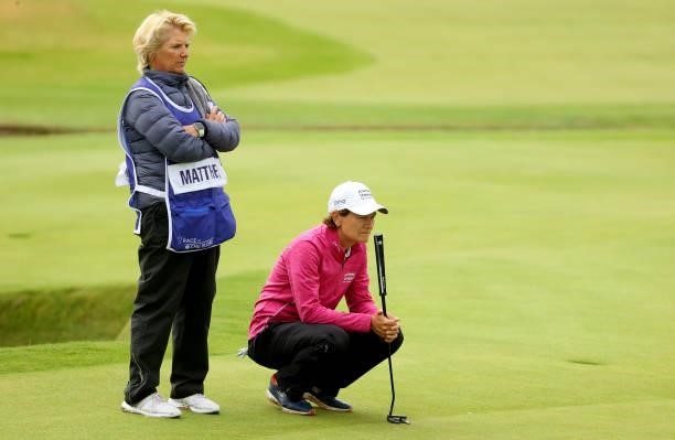 Catriona Matthew of Scotland and her caddie on the 18th green during the first round of the AIG Women's Open at Carnoustie Golf Links on August 19,...