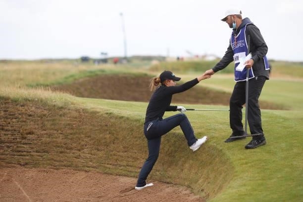 Jenny Shin of The United States is helped out of a bunker by her caddie after playing her second shot on the fourteenth hole during Day One of the...