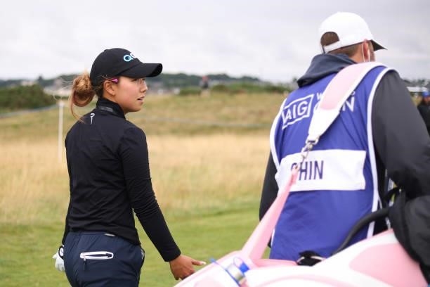 Jenny Shin of The United States talks with her caddie as they walk down the fourteenth hole during Day One of the AIG Women's Open at Carnoustie Golf...