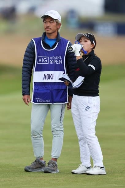 Serena Aoki of Japan takes a drink from an official AIG Women's Open water bottle during Day One of the AIG Women's Open at Carnoustie Golf Links on...