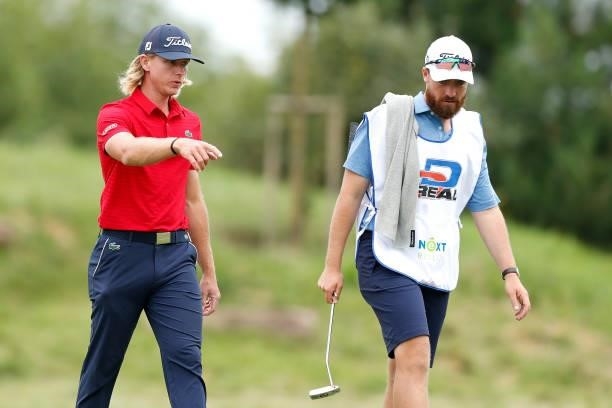 Maverick Antcliff of Australia speaks with his caddie on the 16th hole during Day One of The D+D Real Czech Masters at Albatross Golf Resort on...