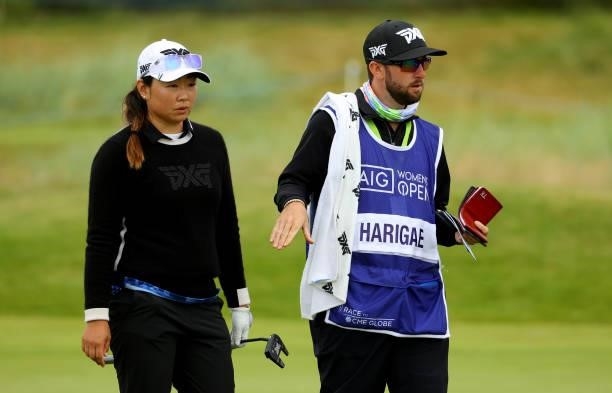 Mina Harigae of The United States and her caddie on the 14th green during the first round of the AIG Women's Open at Carnoustie Golf Links on August...