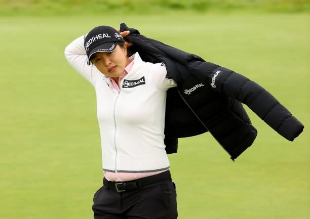 Sei Young Kim of South Korea puts her jacket back on after her putt on the 14th green during the first round of the AIG Women's Open at Carnoustie...