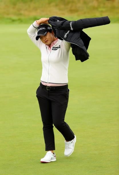 Sei Young Kim of South Korea puts her jacket back on after her putt on the 14th green during the first round of the AIG Women's Open at Carnoustie...