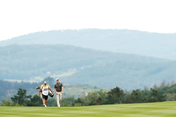 Bryce Easton of South Africa makes his way along the ninth hole with his caddie during Day One of The D+D Real Czech Masters at Albatross Golf Resort...