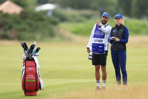 Sanna Nuutinen of Finland talks with her caddie as she prepares to play her second shot on the tenth hole during Day One of the AIG Women's Open at...
