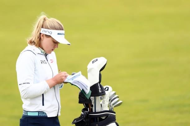 Brooke Henderson of Canada reads her yardage booklet during Day One of the AIG Women's Open at Carnoustie Golf Links on August 19, 2021 in...