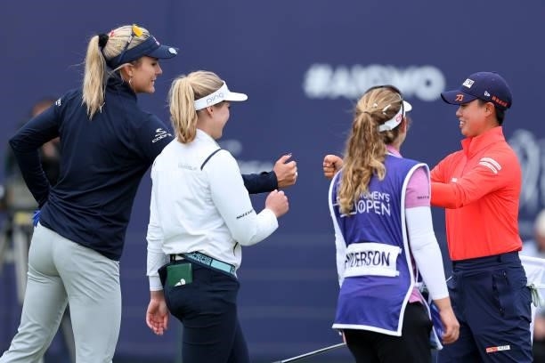 Lexi Thompson of The United States, Brooke Henderson of Canada and Yuka Saso of Philippines fist bump on the eighteenth green during Day One of the...