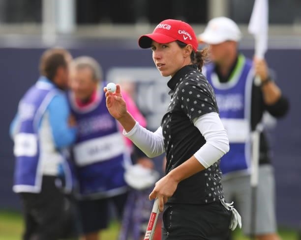 Carlota Ciganda of Spain acknowledges the crowd after putting in on on the eighteenth green during Day One of the AIG Women's Open at Carnoustie Golf...