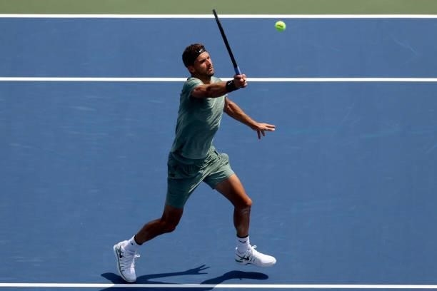 Grigor Dimitrov of Bulgaria returns a shot to Daniil Medvedev of Russia during the Western & Southern Open at Lindner Family Tennis Center on August...