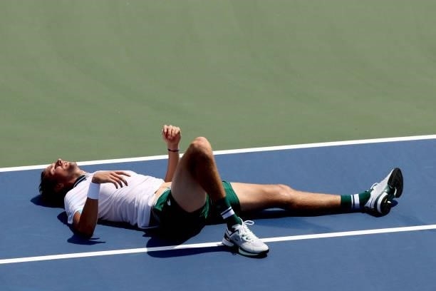 Daniil Medvedev of Russia lays on the court after falling while playing Grigor Dimitrov of Bulgaria during the Western & Southern Open at Lindner...