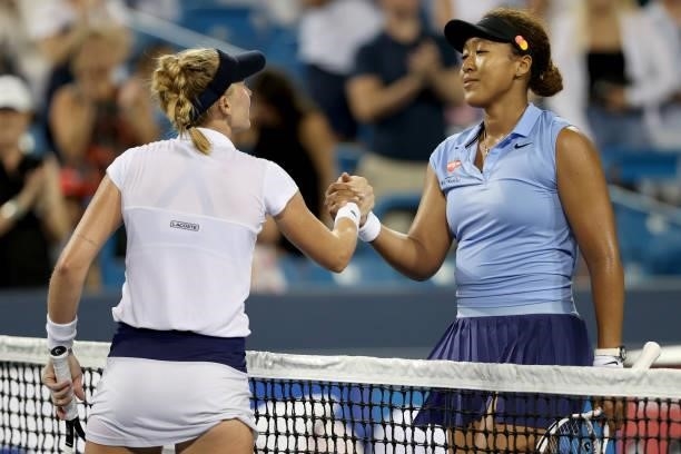 Jill Teichmann of Switzerland is congratulated at the net by Naomi Osaka of Japan during the Western & Southern Open at Lindner Family Tennis Center...