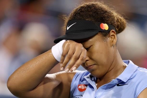 Naomi Osaka of Japan wipes her forehead while playing Jill Teichmann of Switzerland during the Western & Southern Open at Lindner Family Tennis...