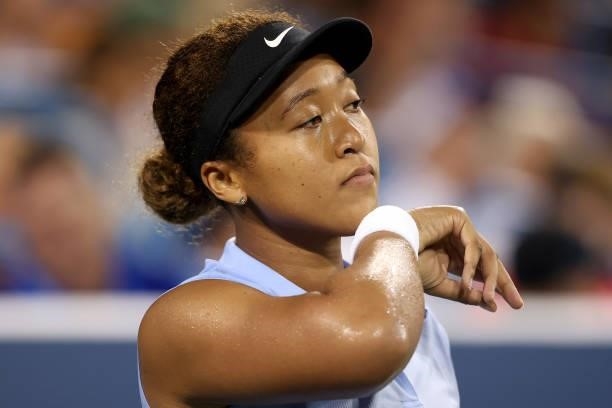 Naomi Osaka of Japan wipes her face while playing Jill Teichmann of Switzerland during the Western & Southern Open at Lindner Family Tennis Center on...