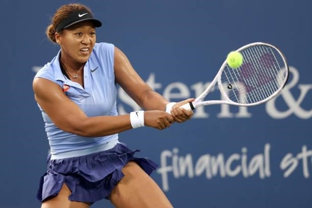 Naomi Osaka of Japan returns a shot to Jill Teichmann of Switzerland during the Western & Southern Open at Lindner Family Tennis Center on August 19,...