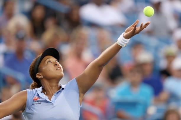 Naomi Osaka of Japan serves to Jill Teichmann of Switzerland during the Western & Southern Open at Lindner Family Tennis Center on August 19, 2021 in...