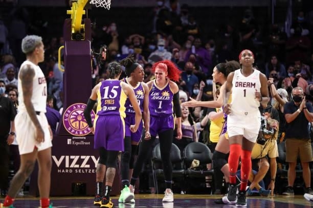 Brittney Sykes, Nneka Ogwumike, and Amanda Zahui B of the Los Angeles Sparks react to their win against the Atlanta Dream at Staples Center on August...