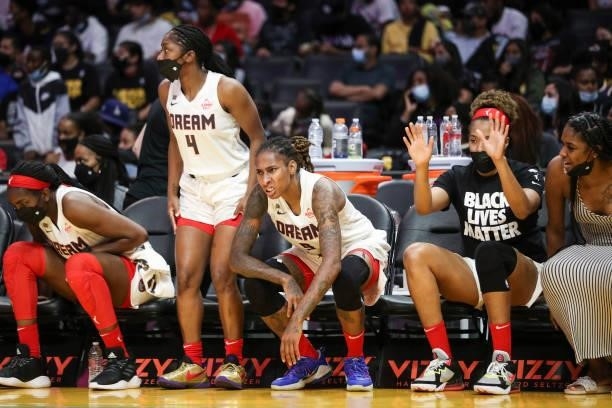 Aari McDonald, Crystal Bradford and Tianna Hawkins of the Atlanta Dream react on the sideline during the first half against the Los Angeles Sparks at...